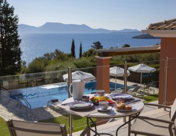 ionian luxury villas levanda lefkada perigiali swimming pool garden view sea mountain chairs table