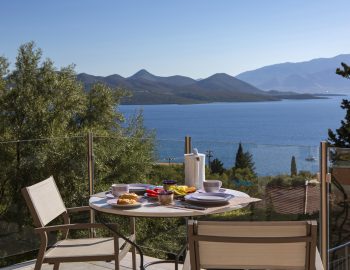 ionian luxury villas levanda lefkada perigiali table food chairs balcony view trees