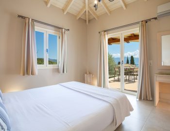 ionian luxury villas olivia lefkada perigiali bedroom view pillows mirror aircondition chairs trees
