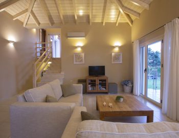 ionian luxury villas olivia lefkada perigiali living room table tv stairs sofa pillow window curtain