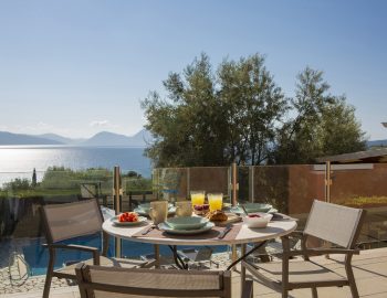 ionian luxury villas olivia lefkada perigiali trees food chairs table balcony sea