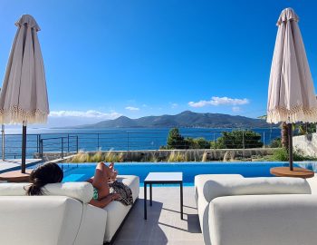 villa empeiria paleros greece umbrella sky girl sitting swimming pool