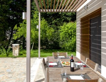 villa giulia sivota lefkada epirus greece table outside garden wine chairs food shadows window