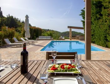 villa guilia sivota lefkada epirus greece swiming pool trees garden wine glasses fruits sky mountain