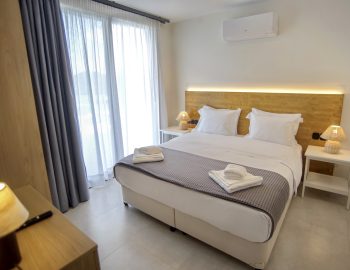villa haris nidri lefkada light bedroom white pillows wood window