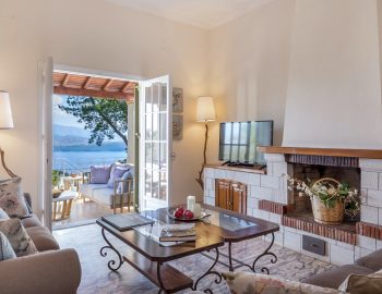 villa leondari kassiopi corfu greece living room with fireplace and view