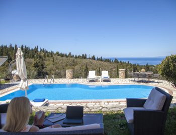 villa nefeli tsoukalades lefkada greece girl on outdoor lounge area looking at ionian sea