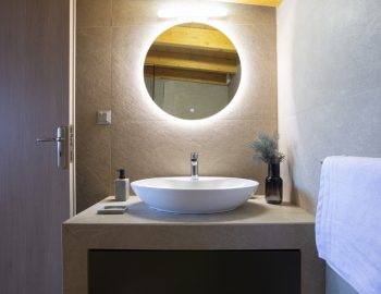villa orama perigiali lefkada greece bathroom round mirror light washbasin
