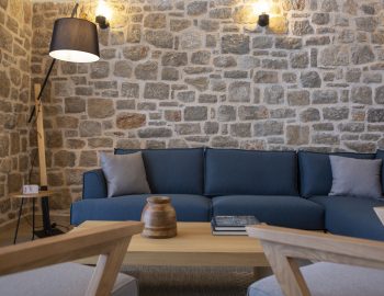 villa orama perigiali lefkada greece sitting area blue sofa pillows stone wall