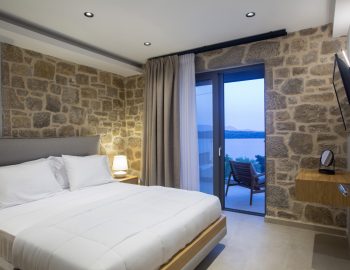 villa orama perigiali lefkada greece stone wall bedroom white bed pillows