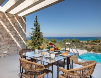 z4 luxury villa lefkada greece table chairs breakfast swimming pool sea view trees